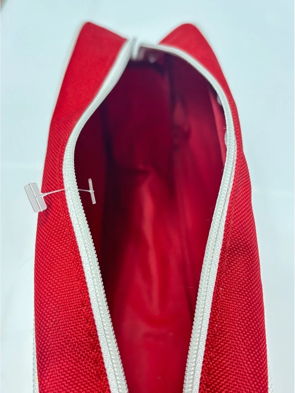 Clinique Red Canvas Cosmetic Bag with White Image Stitching and Zipper Closure